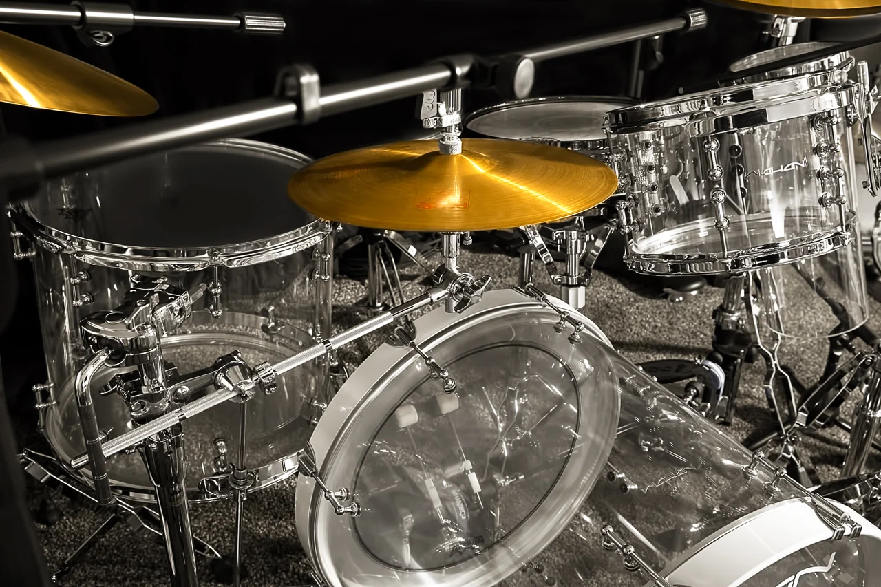 Das Acryl-Schlagzeug im Studio: transparente Kessel mit verchromter Hardware, ein goldenes Becken und die Bassdrum mit weißem Spannreifen